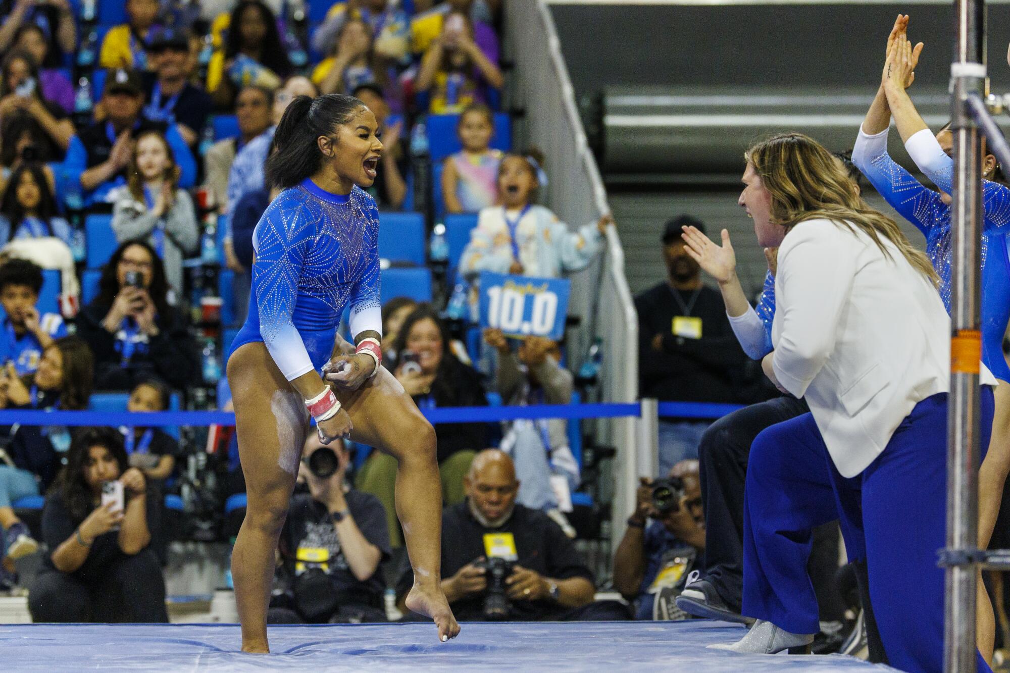 Jordan Chiles celebrates with coach Janelle McDonald after her uneven bar routine Sunday.