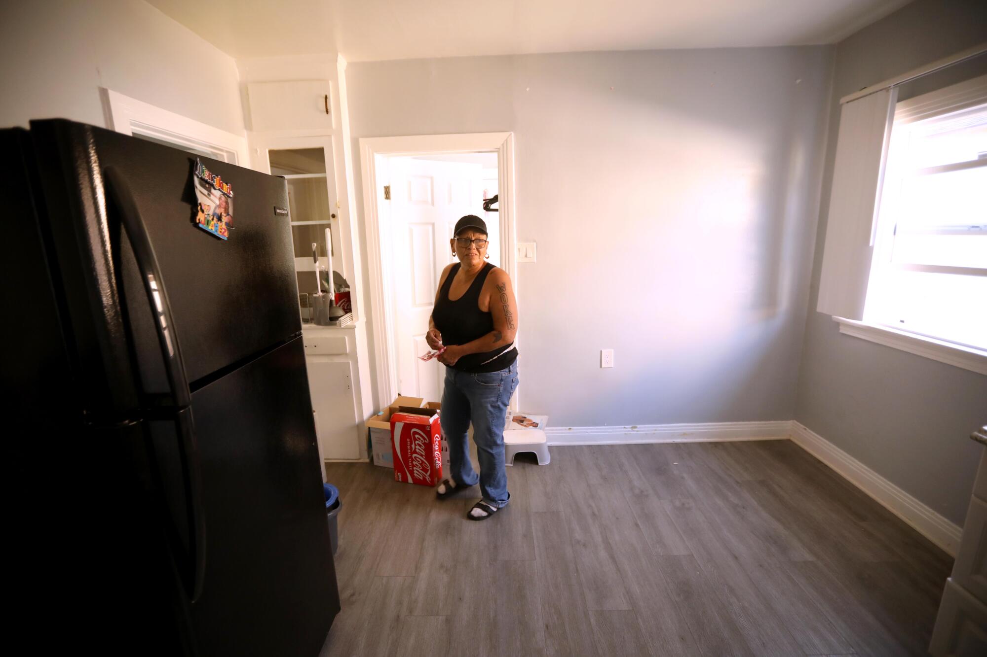 Maria Merritt looks over an empty kitchen on moving day in the home where she lived for four years in El Sereno.