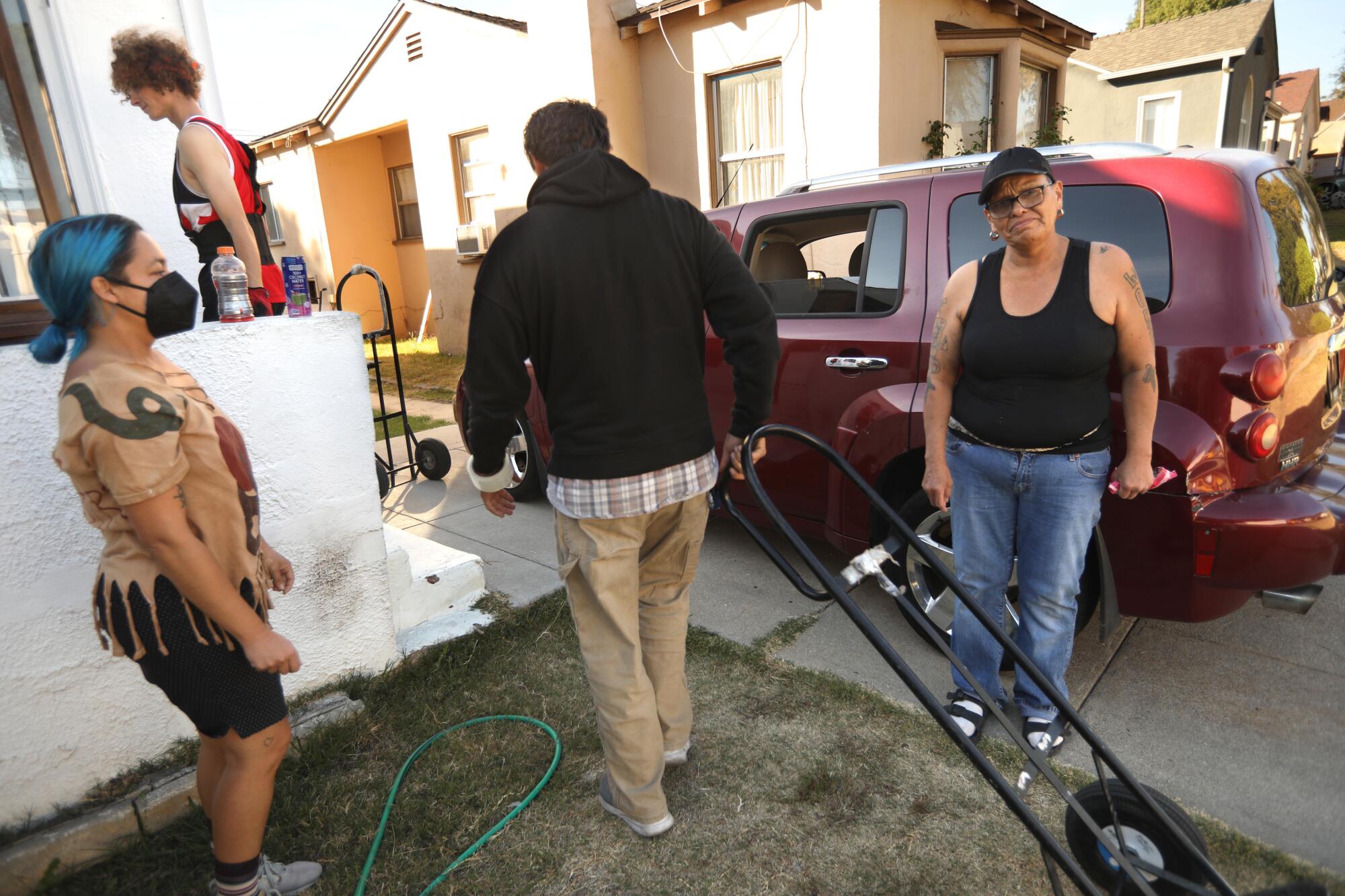 Four people outside a house.