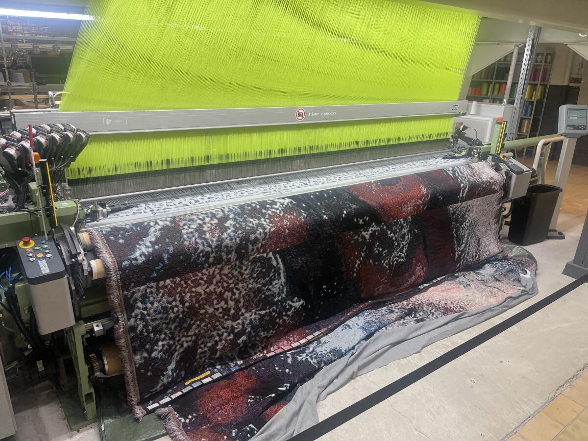 Chartreuse patterned fabric being woven on the jacquard-rapier loom at TextielLab in Tilburg, Netherlands.