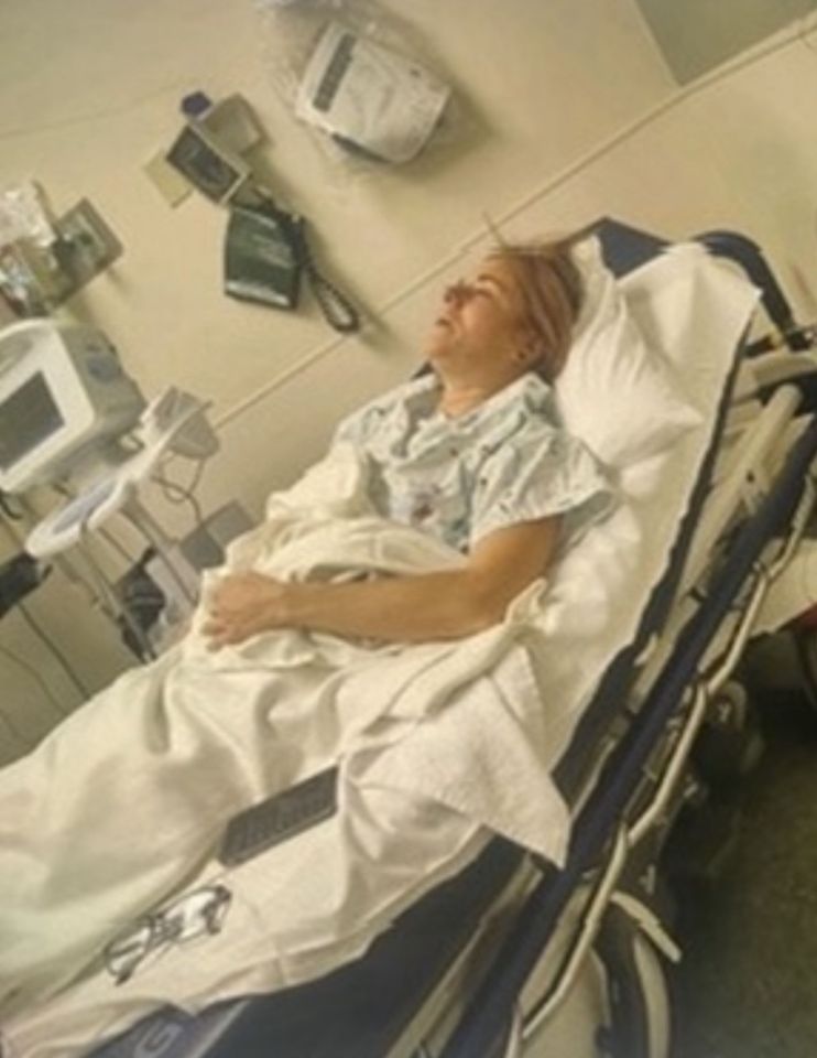 Woman lying in a hospital bed.