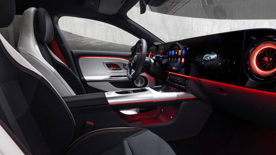 Interior view of a Mercedes-Benz CLA with illuminated dashboard and seats.