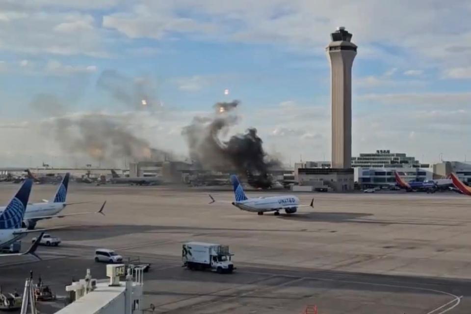 American Airlines plane fire at Denver International Airport, passengers evacuated.