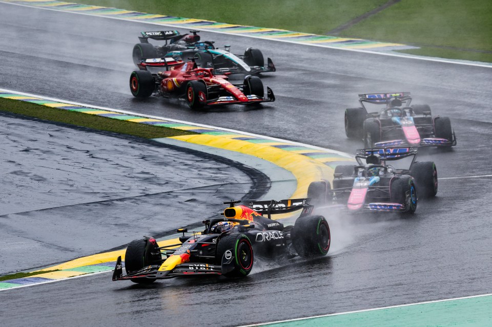 Formula 1 cars racing in the rain.