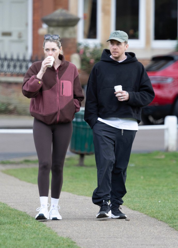 Danny and Georgia Jones walking and drinking coffee.