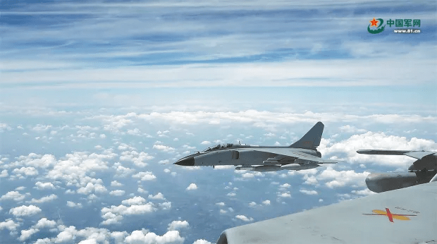 Fighter jet flying above the clouds.