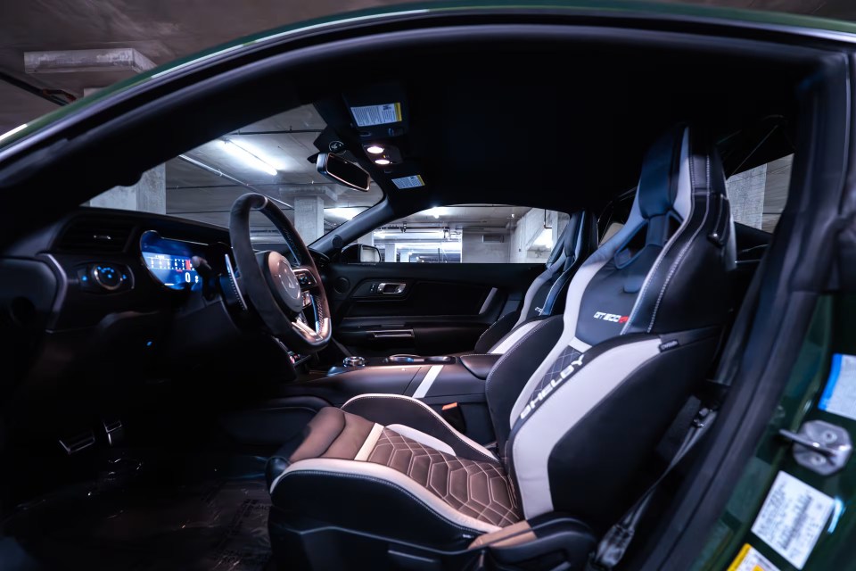 Interior view of a green Shelby GT500KR with Recaro seats.