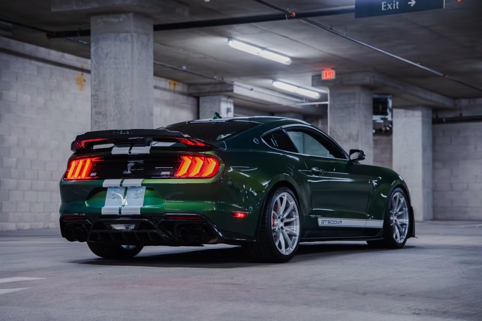 Rear view of a green Shelby GT500KR in a parking garage.