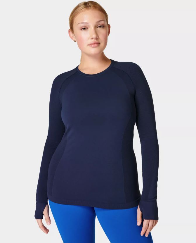 Woman wearing a navy blue long-sleeve athletic top.