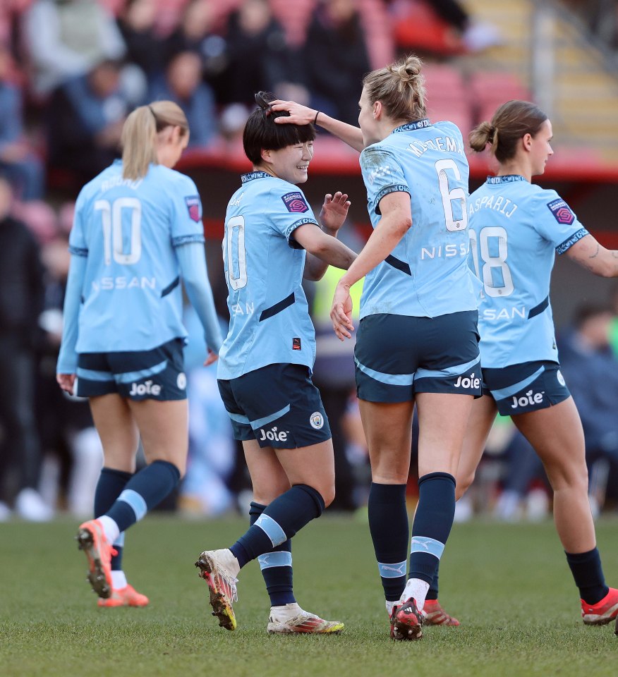 Manchester City Women players celebrating a goal.