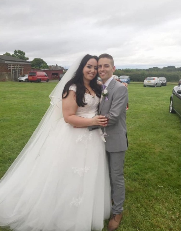 A bride and groom posing for a wedding photo.