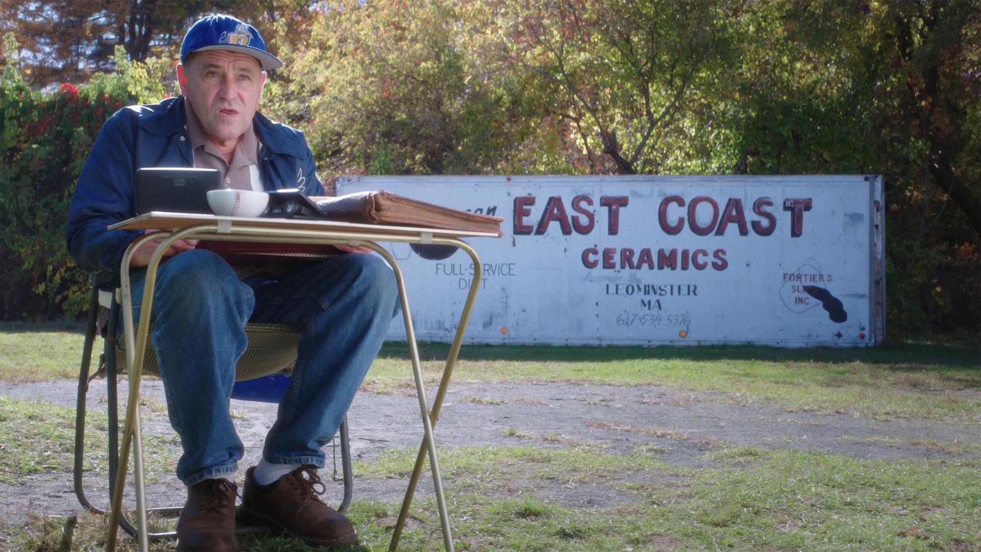 An elderly fan keeps score at a ballgame.