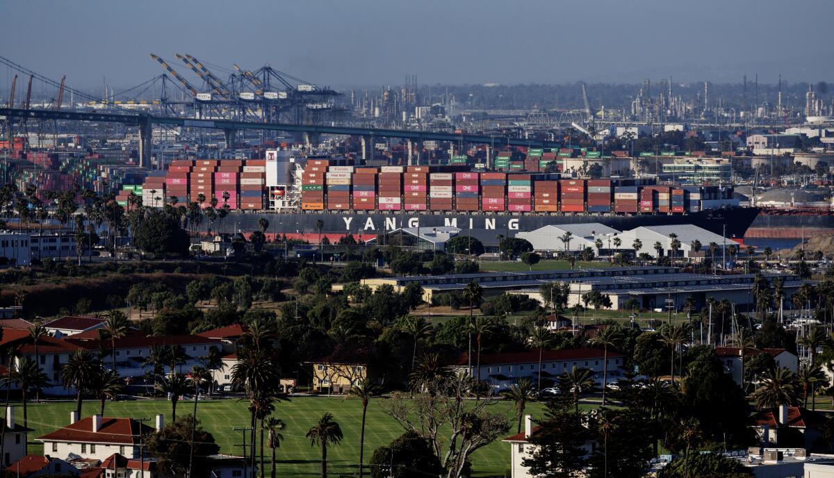 A cargo ship leaves the Port of Los Angeles and heads out to sea.