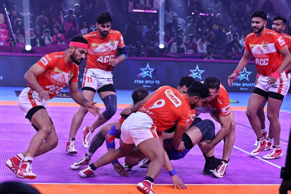 Kabaddi players in action during a match.