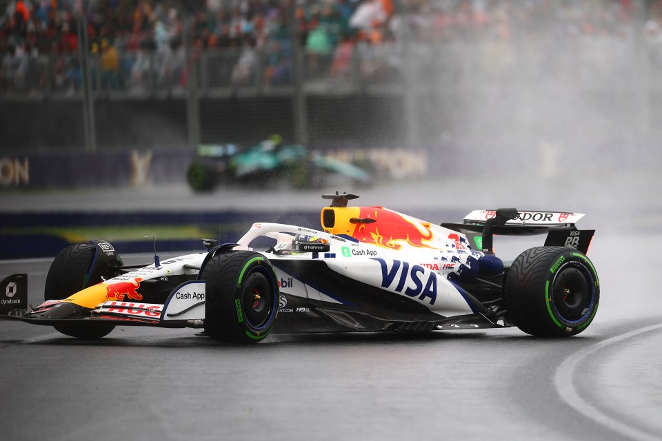 Formula 1 car driving in the rain.