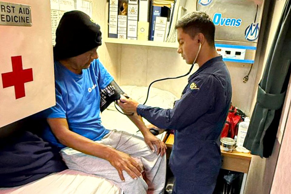 A Peruvian Navy medic takes a fisherman's blood pressure.