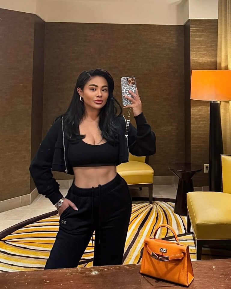 Woman taking a selfie in a hotel room.