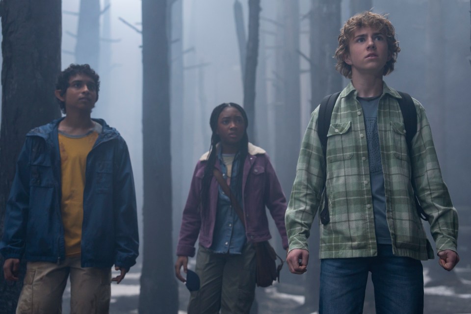 Still from Percy Jackson And The Olympians showing Percy Jackson, Annabeth Chase, and Grover Underwood in a forest.