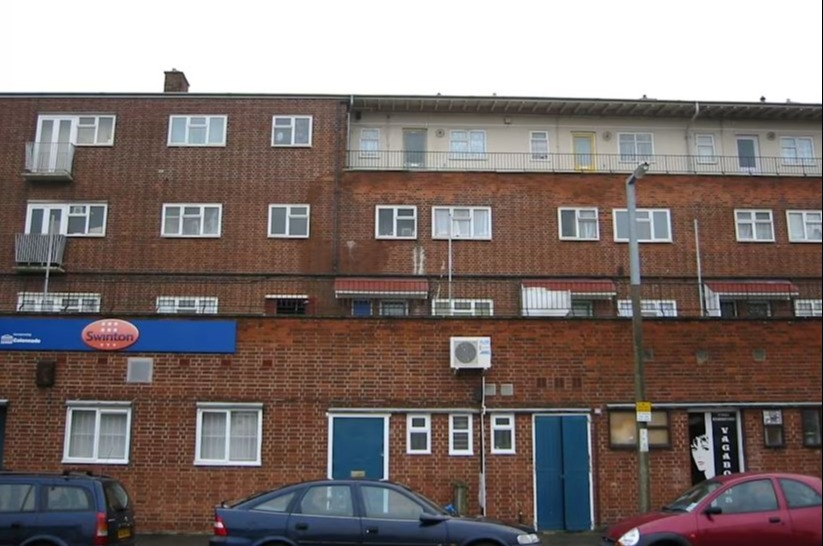 Brick building with Swinton sign and blue doors.