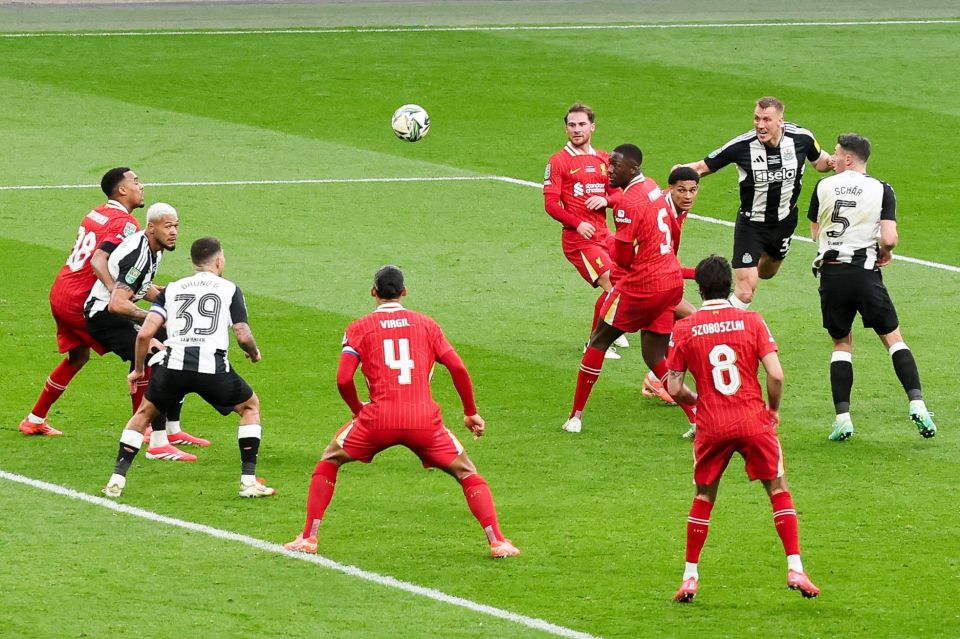 Dan Burn scoring a header goal for Newcastle United against Liverpool.