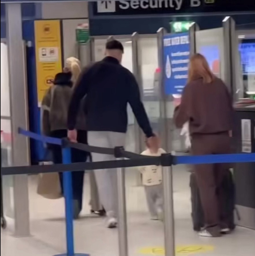 Molly Mae and Tommy Fury at the airport with their child.