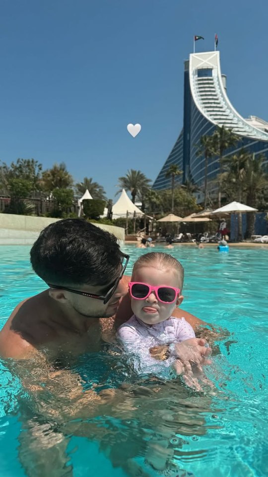 Tommy Fury and his daughter in a pool.