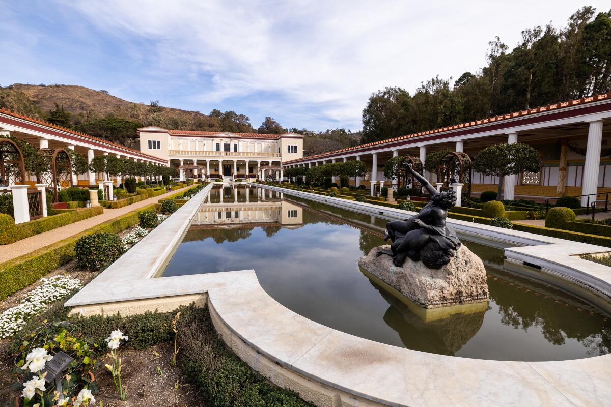 The Getty Villa pool, usually clear is filled with ash from the Palisades fire.