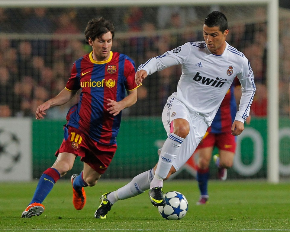 Lionel Messi and Cristiano Ronaldo vying for the ball during a soccer match.