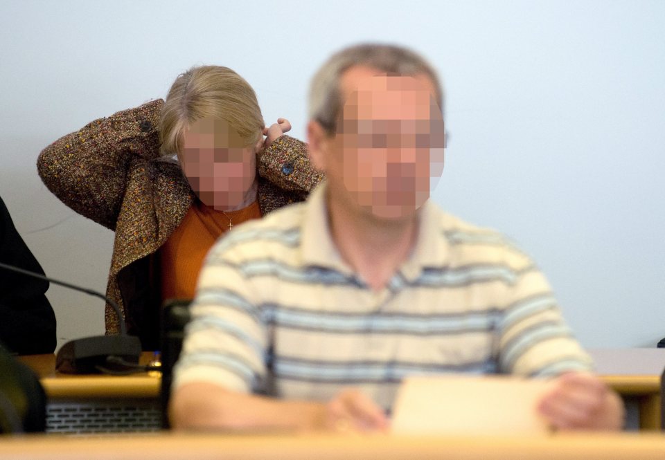 Photo of a man and woman in court, faces pixelated.