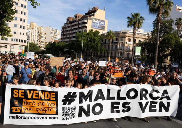 Protesters hold a banner reading "Mallorca is not for sale" during a demonstration to protest against the massification of tourism and housing prices on the island of Mallorca in Palma de Mallorca on May 25, 2024. 