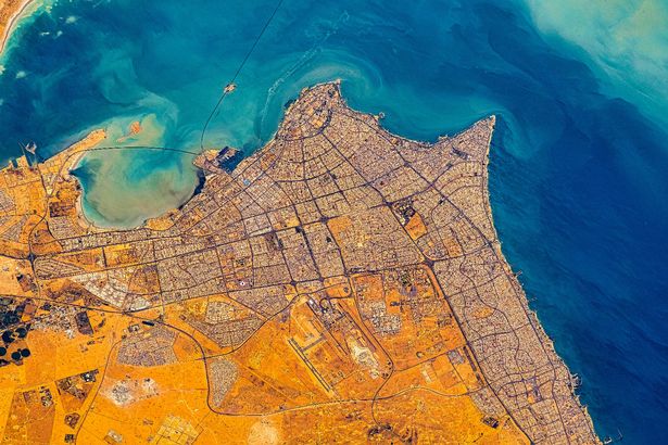 Kuwait City and surrounding areas. Digital Enhancement. Elements by Nasa. Usage guidelines: https://www.nasa.gov/multimedia/guidelines/index.html