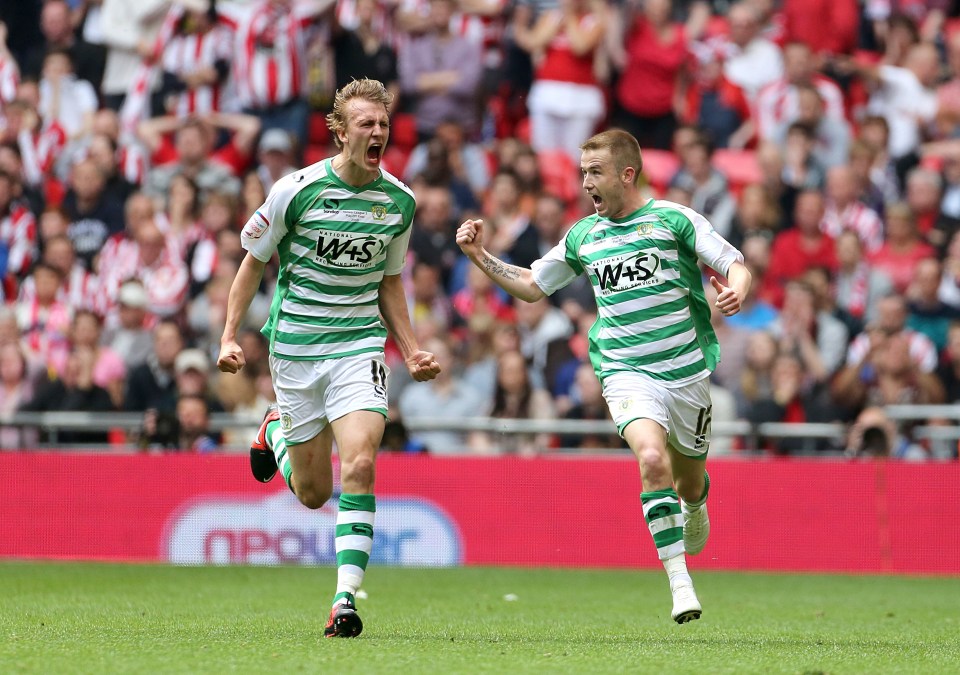 Two soccer players celebrating a goal.