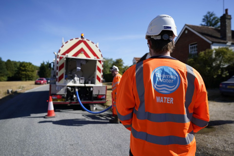 Thames Water worker delivering water from a tanker.