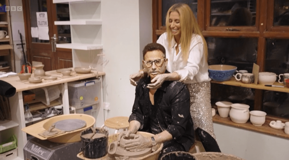 Stacey Solomon and Joe Swash working with clay on a pottery wheel.