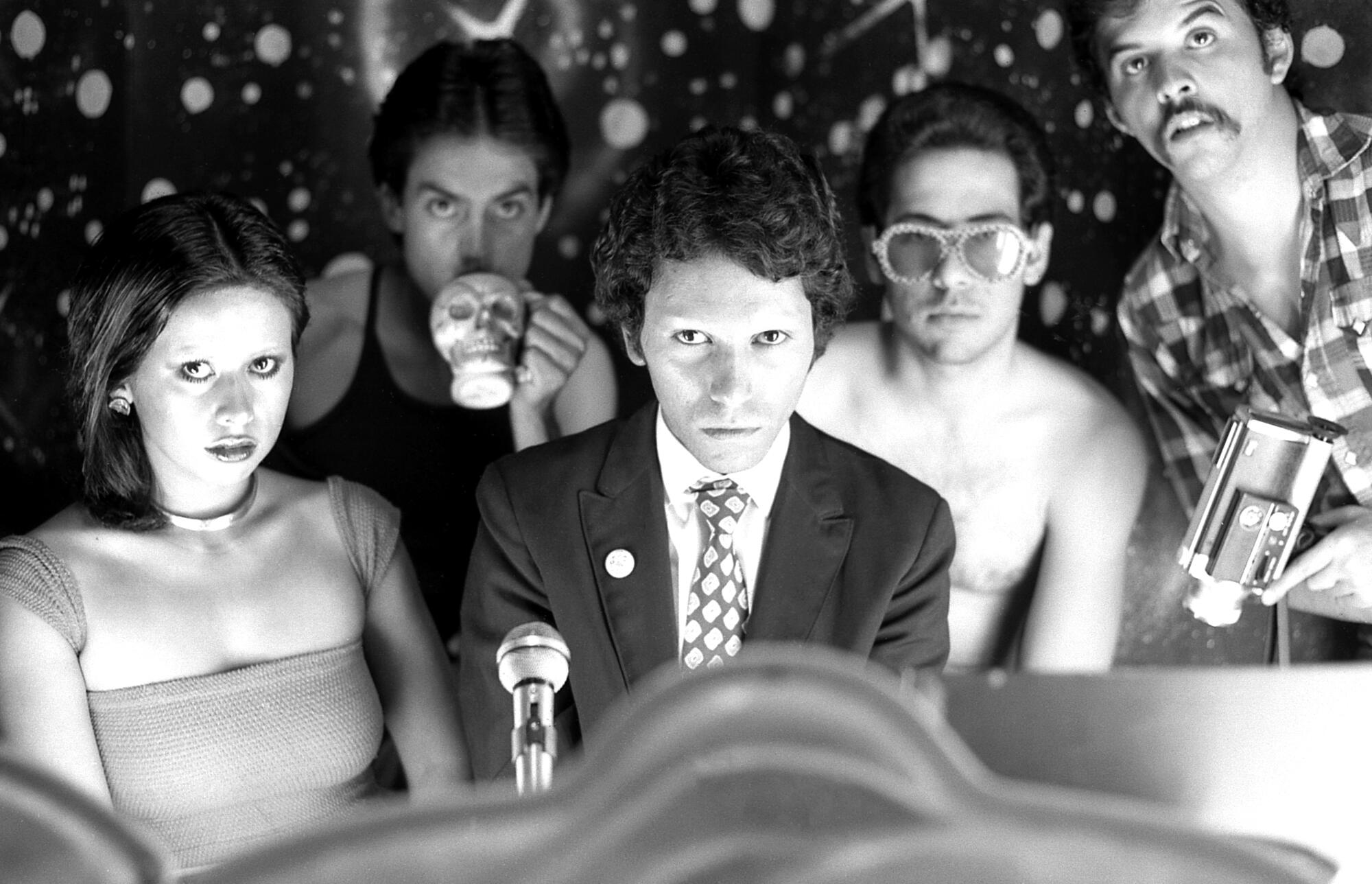 In a black and white image, five Asco members glare into the camera.