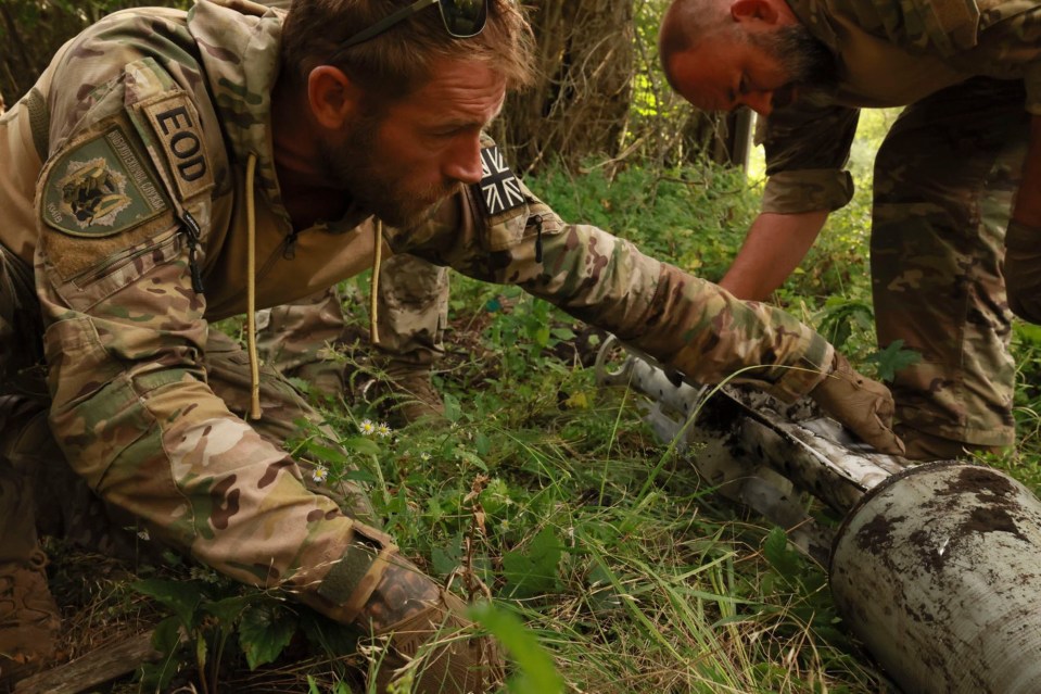 British bomb disposal experts disarm a Russian munition in Ukraine.