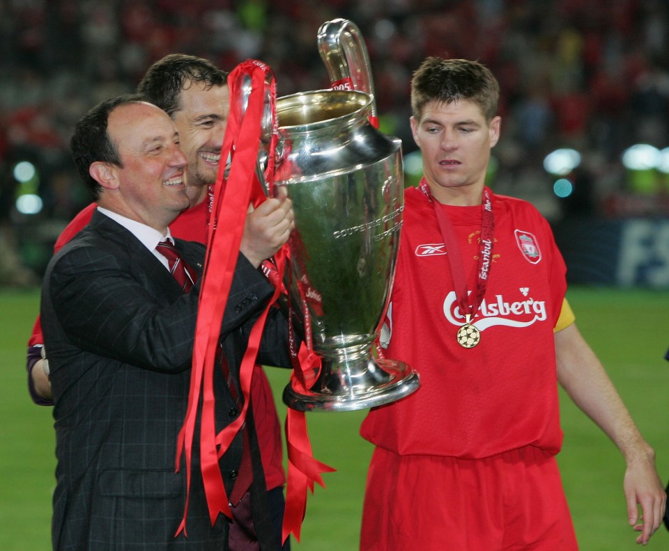 Liverpool manager Rafael Benitez, captain Steven Gerrard, and goalkeeper Jerzy Dudek holding the Champions League trophy.