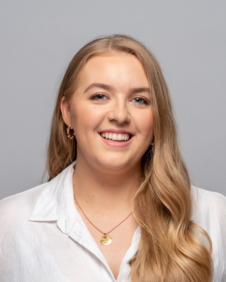 Portrait of a smiling woman with long blonde hair.