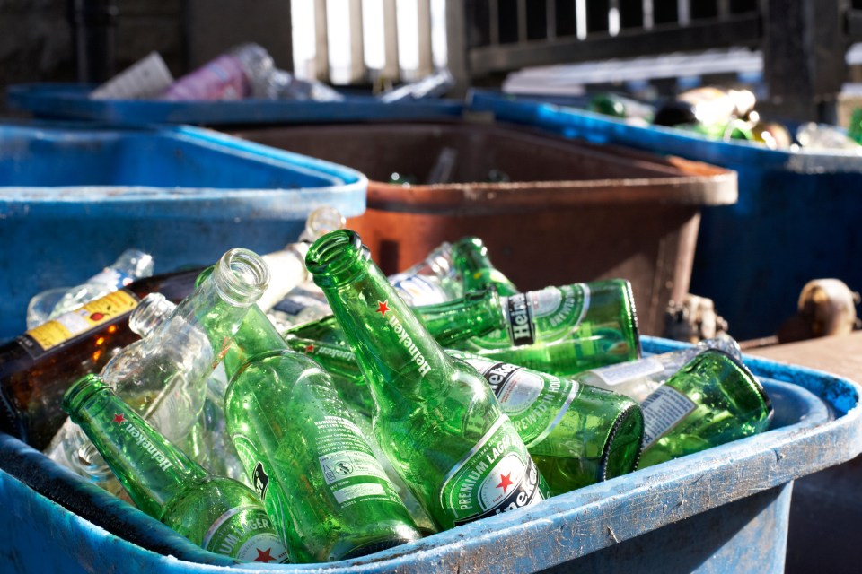 Recycling bin full of empty beer bottles.