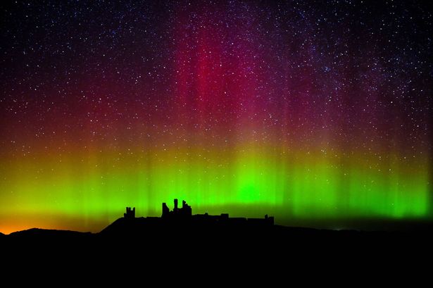  the Northern Lights, or Aurora Borealis, at Dunstanburgh Castle in Northumberland.