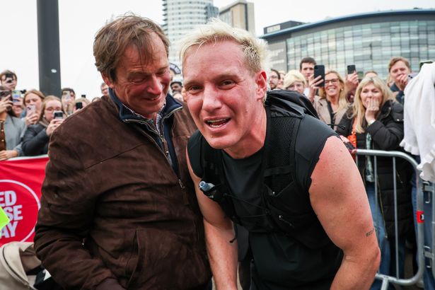 Jamie Laing celebrates at the finish line with his father Nicholas Laing