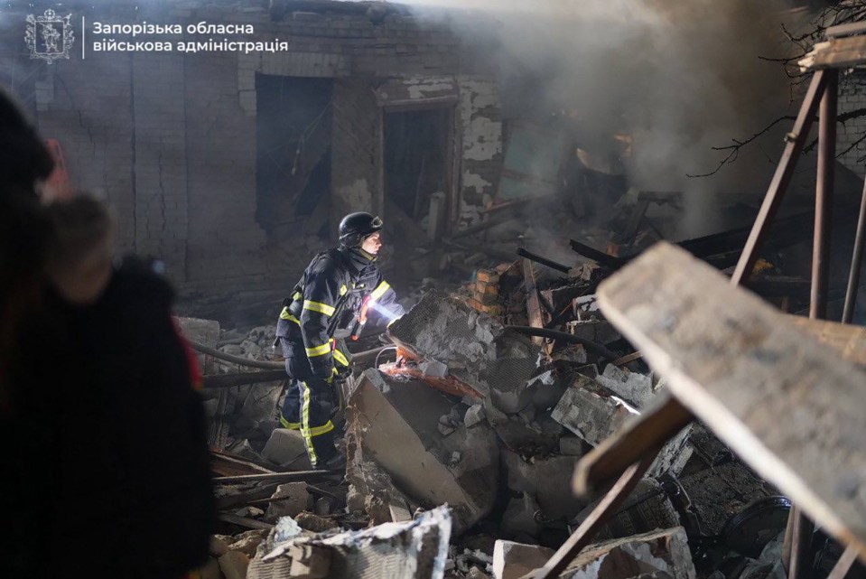 A firefighter searches through the rubble of a destroyed building in Zaporizhzhia, Ukraine.