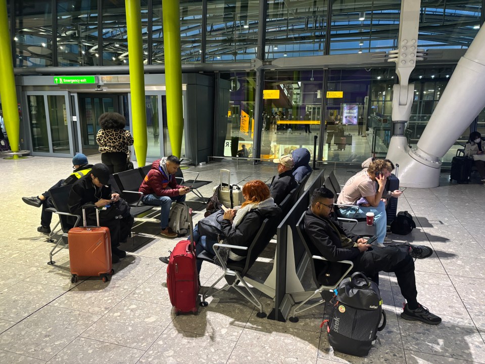 Passengers waiting in Heathrow Airport.