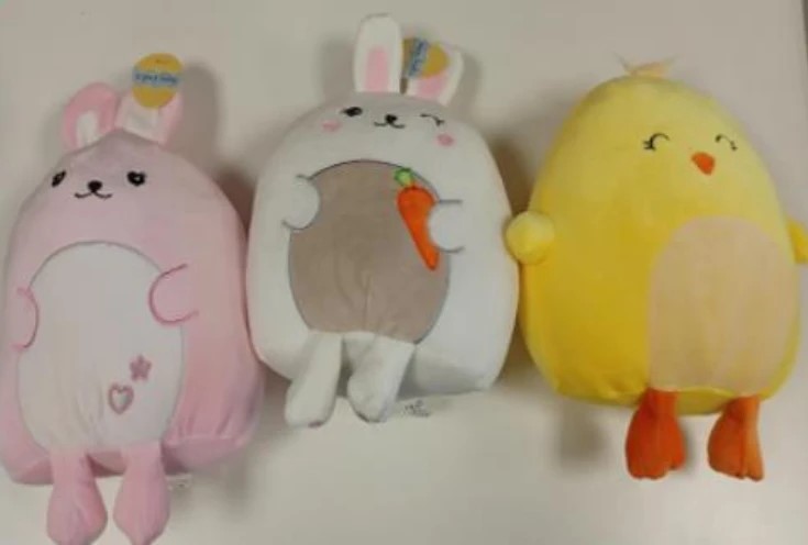 Three plush toys: a pink bunny, a white bunny holding a carrot, and a yellow chick.