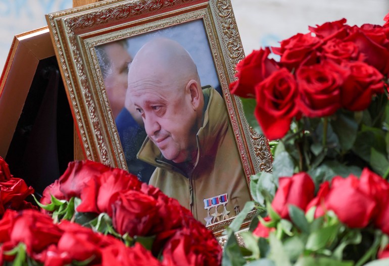 A view shows a framed photo of Russian mercenary chief Yevgeny Prigozhin at his grave at the Porokhovskoye cemetery in Saint Petersburg, Russia