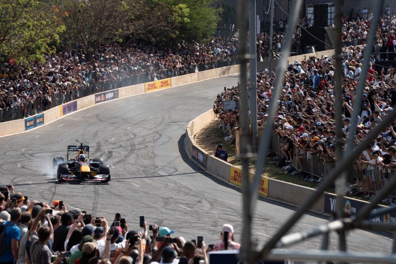 David Coulthard, a former Formula 1 driver, drives the Red Bull RB7 through the streets of the Sandton CBD as part of the Red Bull Showrun in Johannesburg, South Africa, October 6, 2024. REUTERS/Ihsaan Haffejee