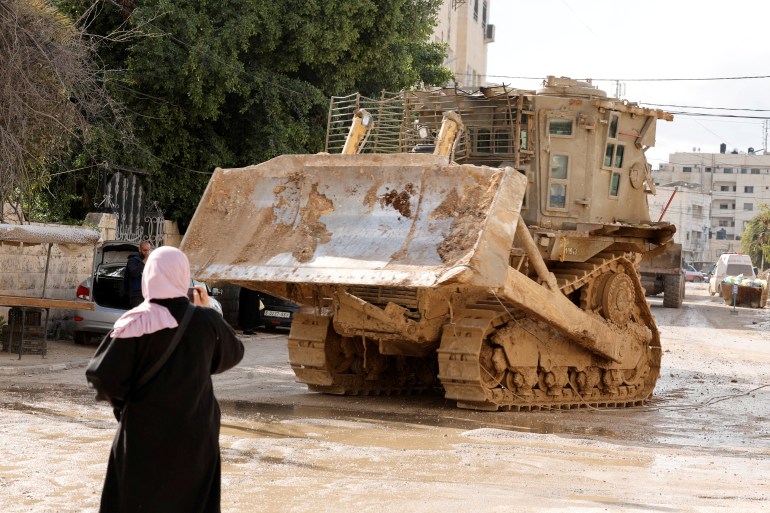 FILE PHOTO: An Israeli military vehicle drives on the street during an Israeli raid, in Jenin in the Israeli-occupied West Bank, February 24 2025. REUTERS/Raneen Sawafta/File Photo