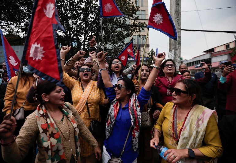 Pro-monarchy supporters demanding the restoration of monarchy, which was abolished in 2008, chant slogans as they wait to welcome former King of Nepal Gyanendra Bir Bikram Shah Dev, outside the Tribhuvan International Airport in Kathmandu, Nepal March 9, 2025. REUTERS/Navesh Chitrakar