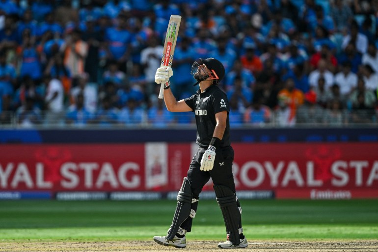 New Zealand's Daryl Mitchell celebrates after scoring a half-century (50 runs) during the ICC Champions Trophy one-day international (ODI) final cricket match between India and New Zealand at the Dubai International Stadium in Dubai on March 9, 2025. (Photo by Ryan Lim / AFP)