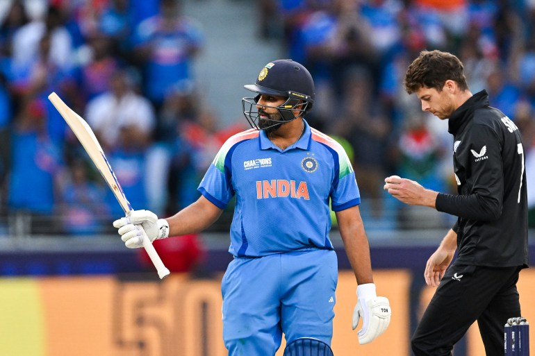 India's captain Rohit Sharma celebrates after scoring a half-century (50 runs) during the ICC Champions Trophy one-day international (ODI) final cricket match between India and New Zealand at the Dubai International Stadium in Dubai on March 9, 2025. (Photo by Ryan Lim / AFP)